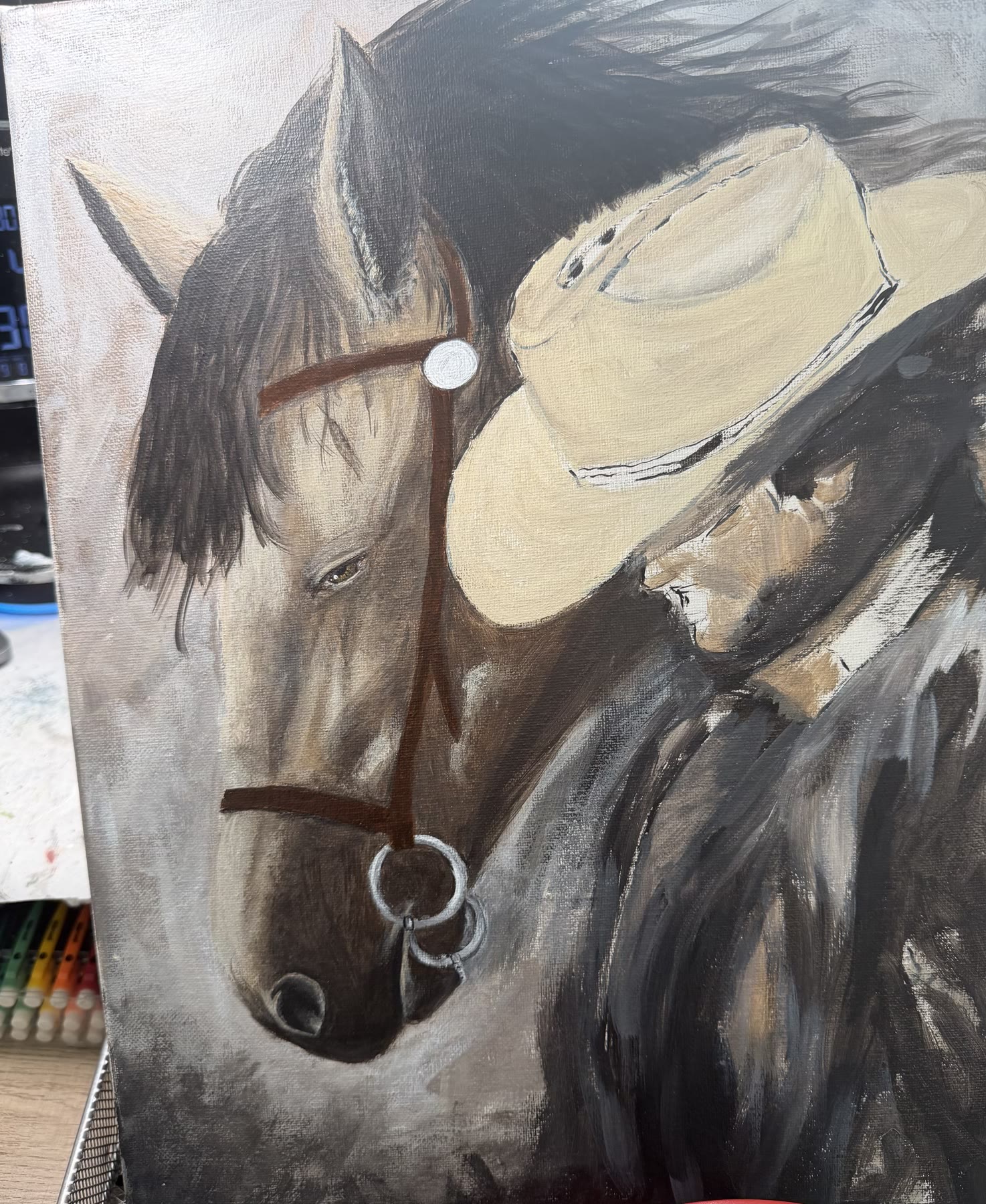 The Cowboy and His Horse partway done on the easel: the horse's head nearly finished, the cowboy still in rough blocks of color.